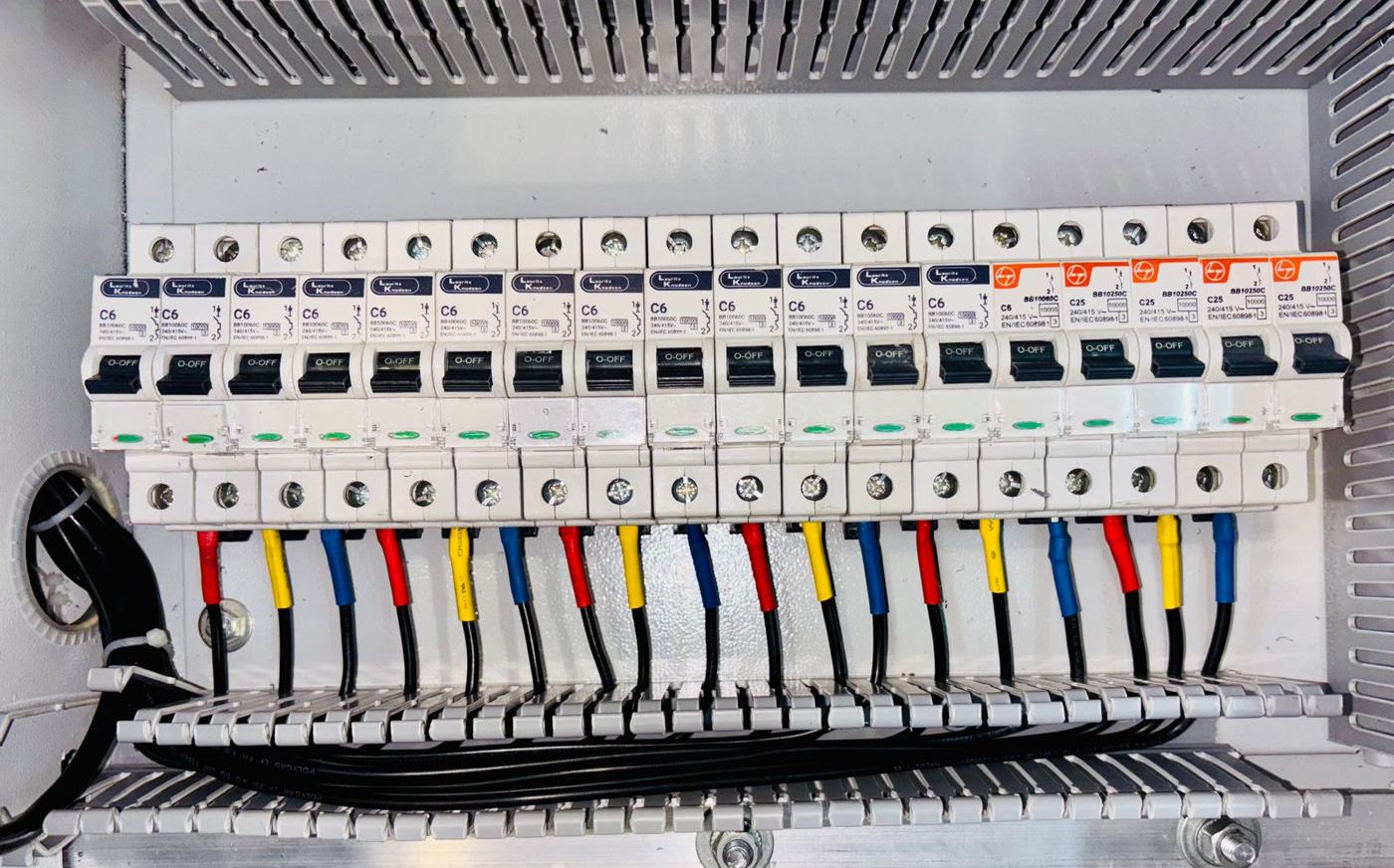 Neatly wired circuit breakers with colour-coded cables