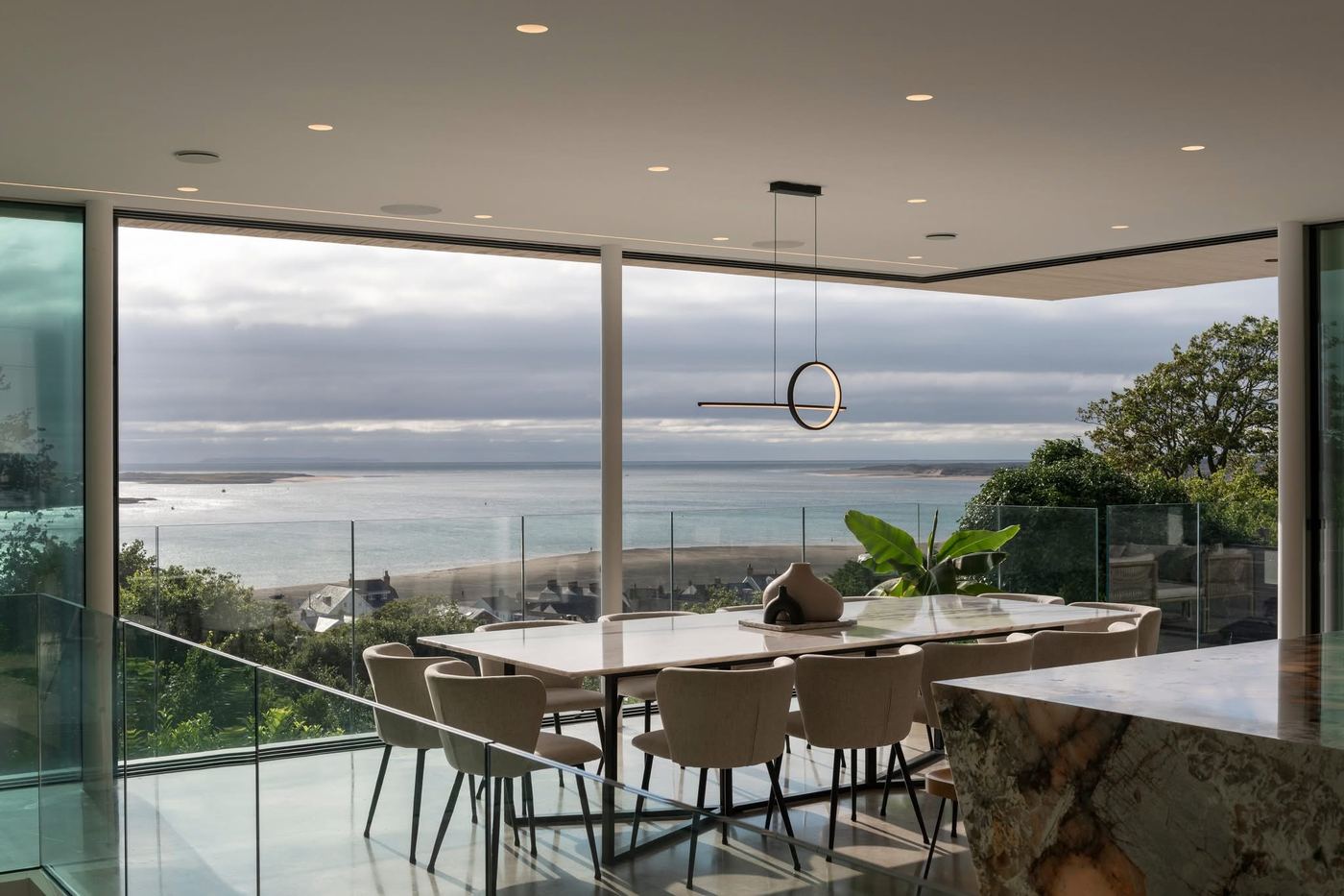 Dining area with recessed downlights and a feature pendant light