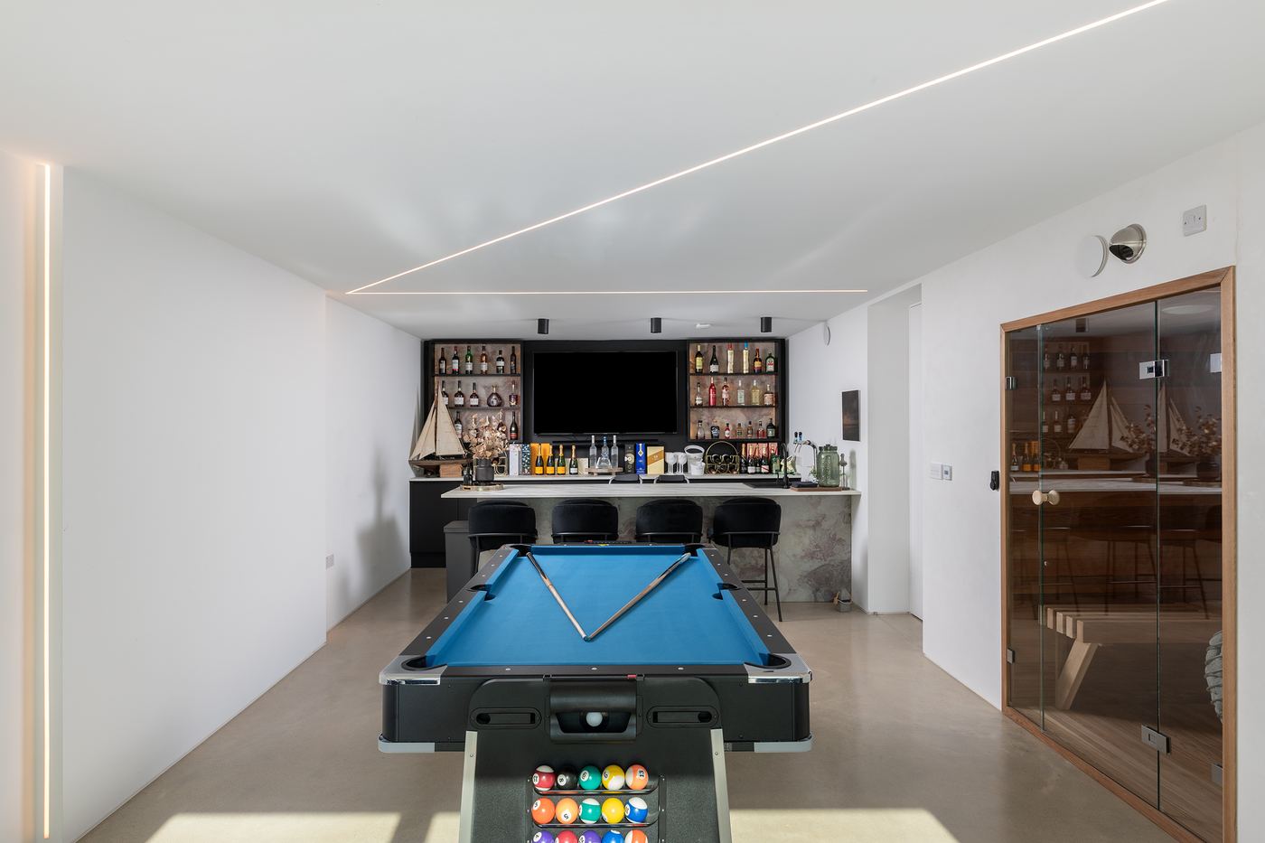 Games room and bar with LED ceiling lines and bar spotlights