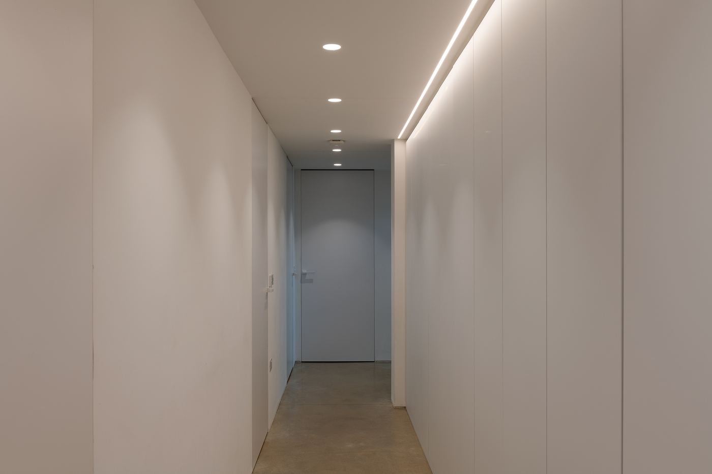 Hallway with recessed downlights and a concealed LED strip
